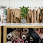 Rolls of assorted fabrics and textiles and sewing patterns inside tailor atelier