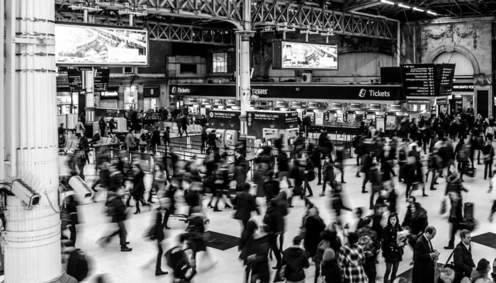 Grayscale Photography of People Walking in Train Station