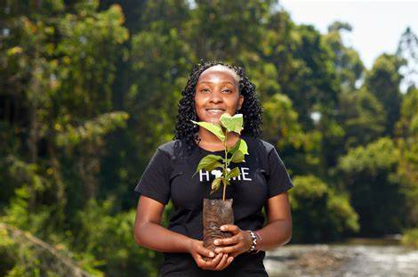 black women holding plant in hand