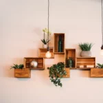 wooden wall decor with lamp and green plants