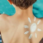 sun drawn in the back of a kid with cream